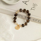 Natural smoky quartz and golden rutilated quartz bracelet, symbolizing protection, abundance, and positive energy.