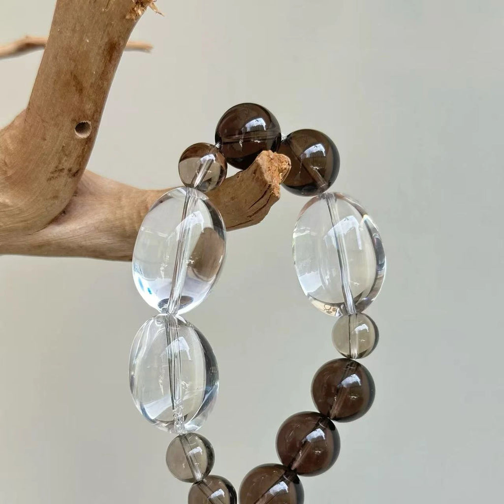 Smoky quartz and clear quartz bracelet featuring translucent brown and crystal-clear stones.