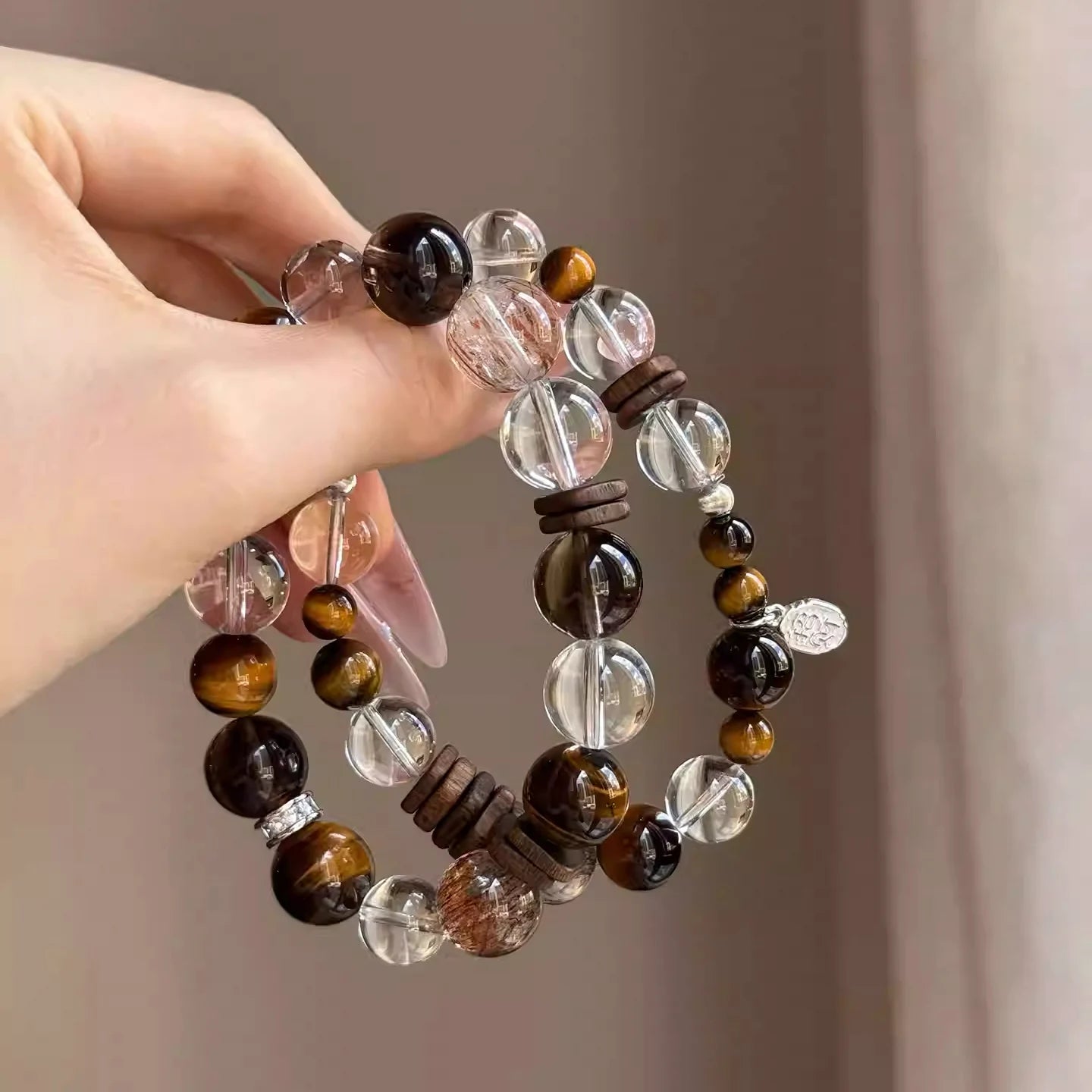 Natural tiger eye and clear quartz bracelet with agarwood beads, promoting focus, positive energy, and spiritual balance.