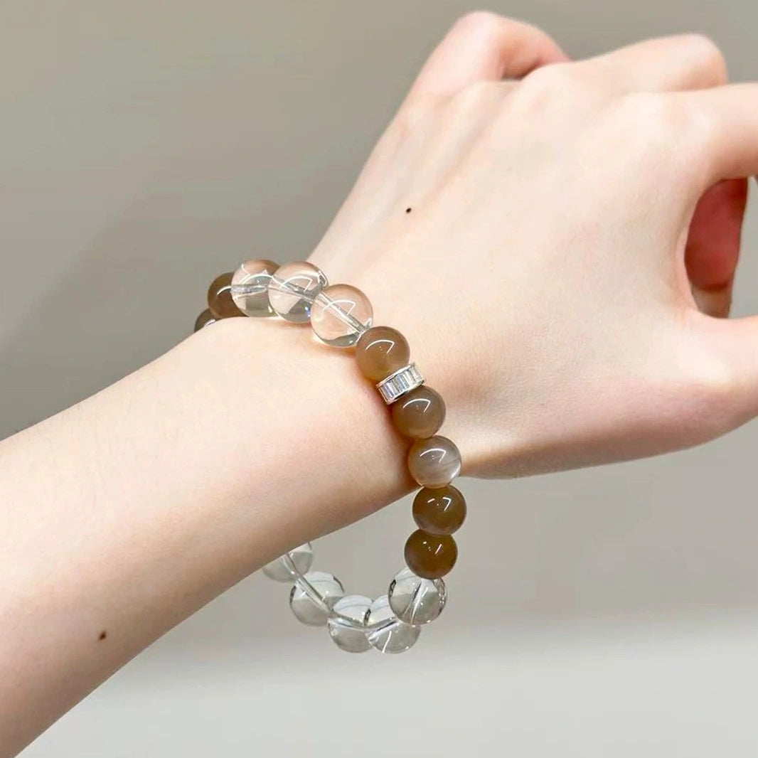 Woman wearing vintage milk tea moonstone, labradorite and clear quartz bracelet for calm emotions, intuitive awareness, and protective energy.